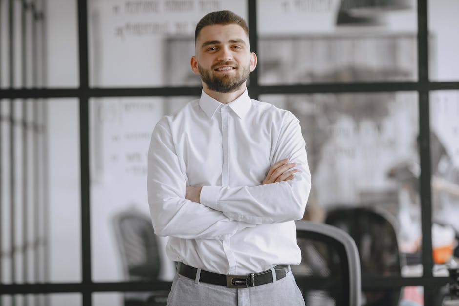 Portrait of a smiling businessman standing confidently in a modern office setting
